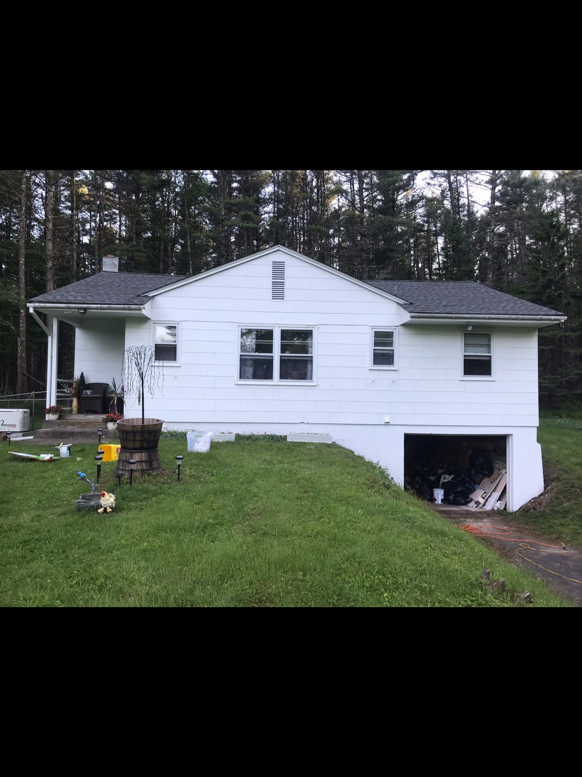 House exterior before renovation with plain white shingle siding