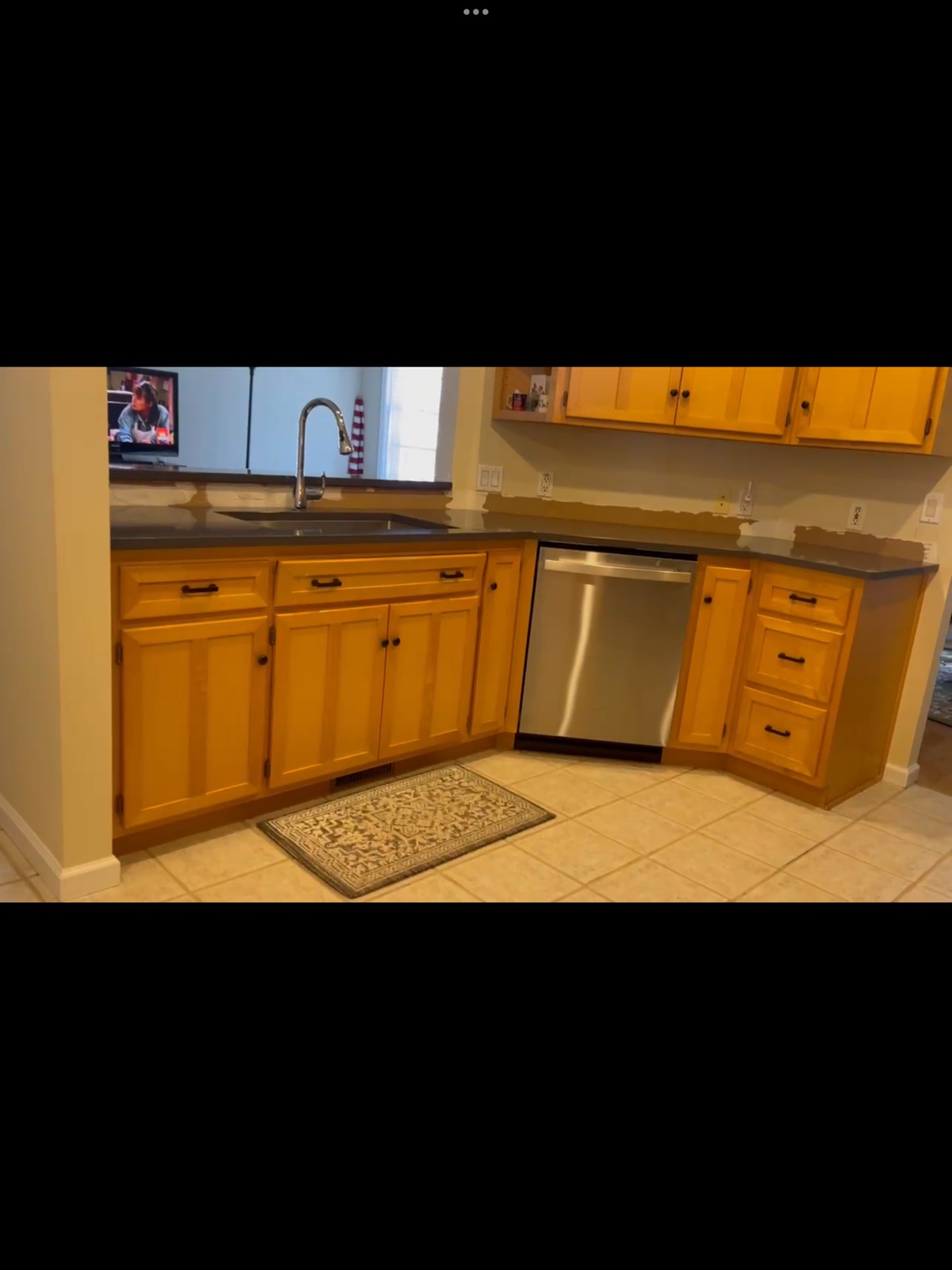 Kitchen with new dark quartz countertops mid-installation