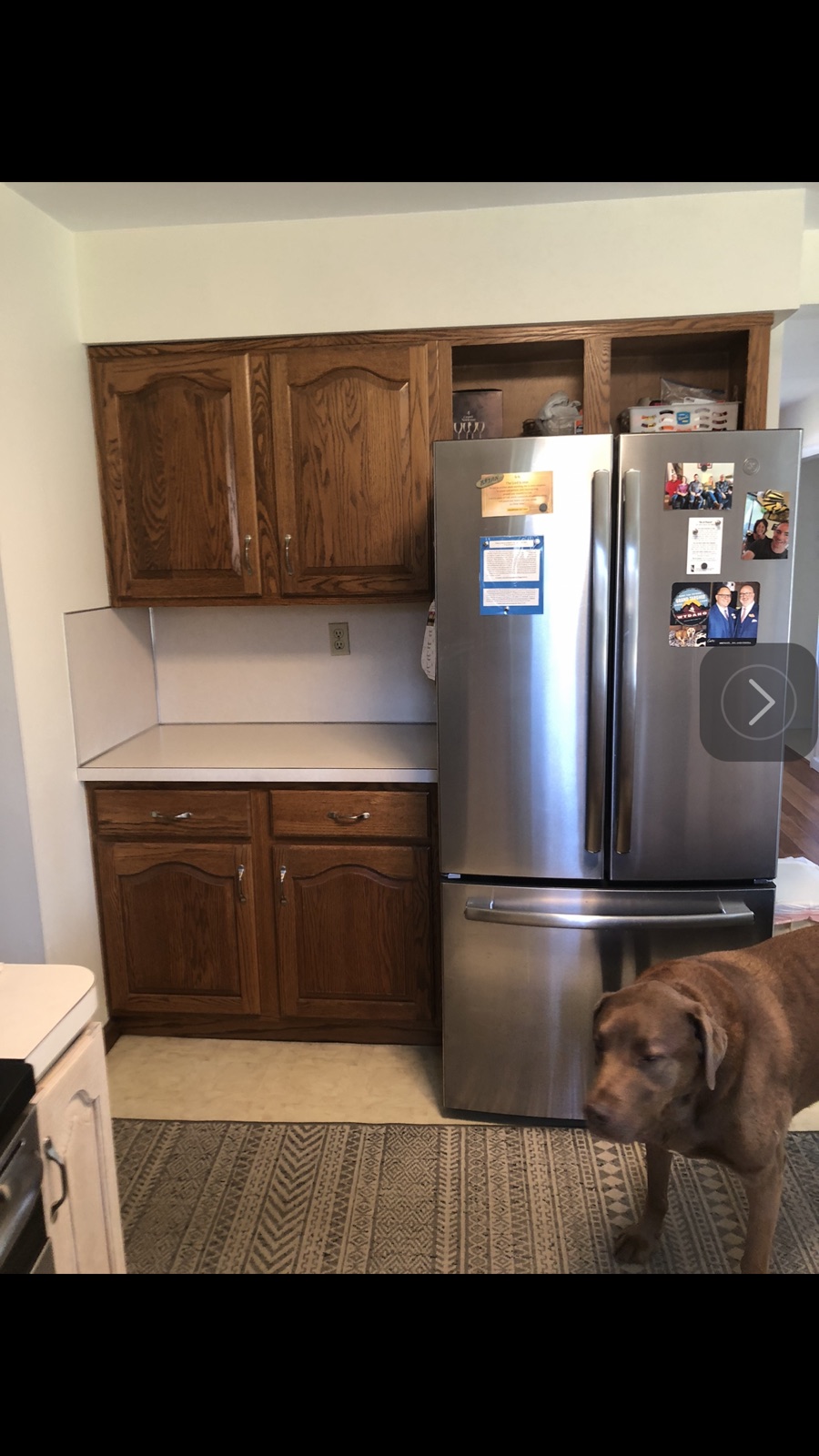 Kitchen before remodel with dated dark oak cabinets