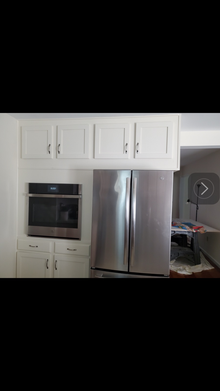 Kitchen remodel with white shaker cabinets, built-in wall oven, and French-door refrigerator