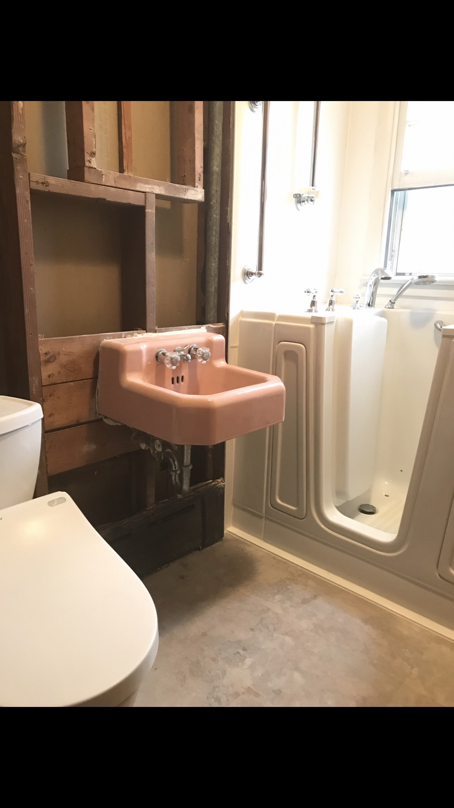 Bathroom renovation in progress with walk-in tub installed