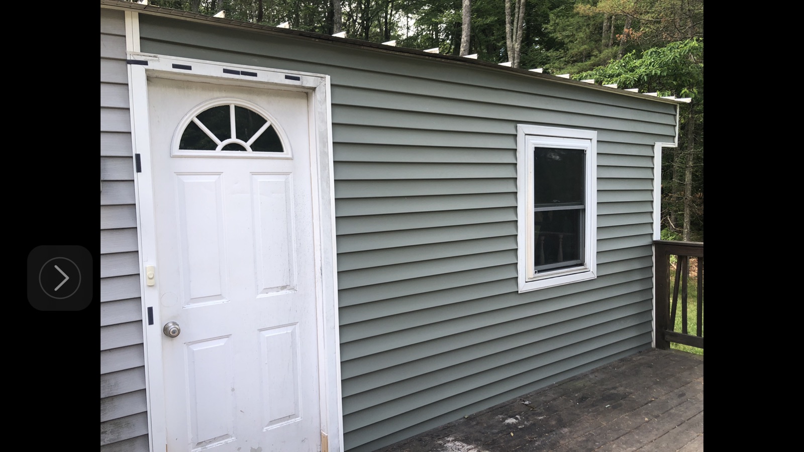 Shed or outbuilding with new gray vinyl siding installed